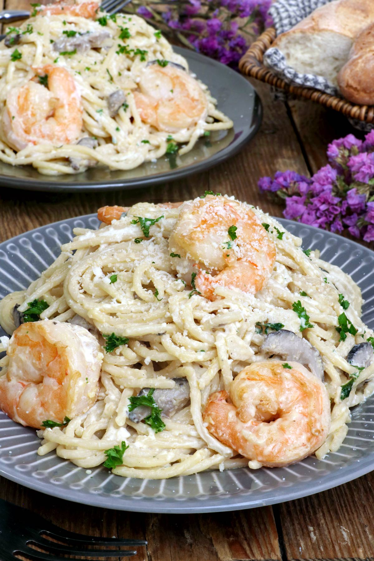 Creamy Prawn Pasta on  serving plates with fresh parsley and parmesan cheese