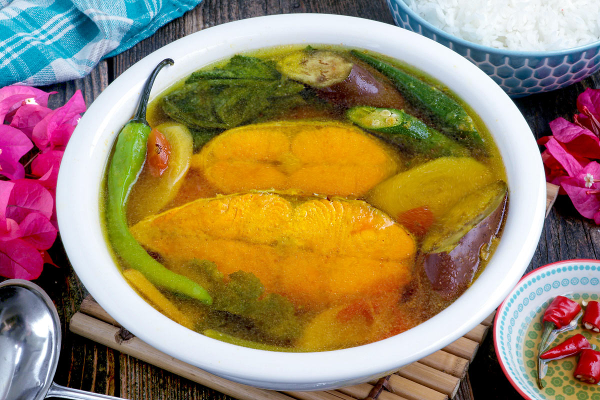 Freshly cooked Sinigang sa Miso in a serving bowl with spiced fish sauce for dipping.