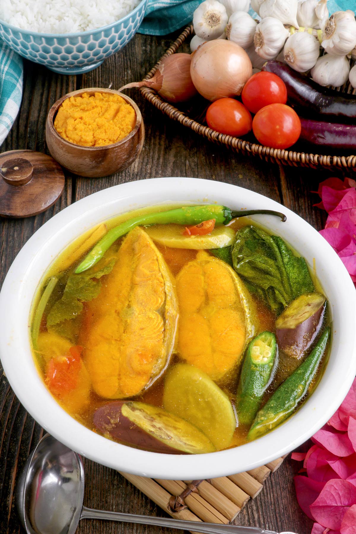 Sinigang sa Miso in a serving bowl made with salmon fillets, fresh veggies and made extra flavorful with miso paste.