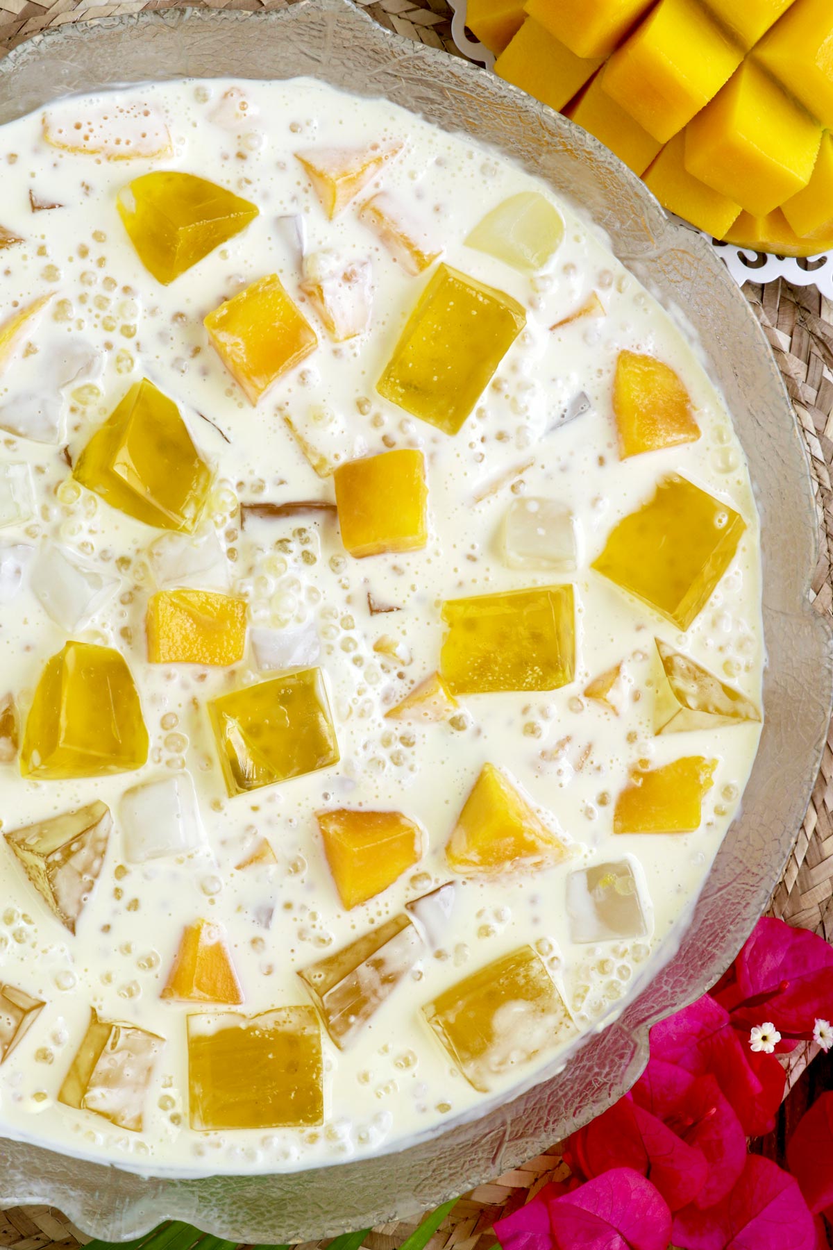 Mango Jelly in a serving bowl with mango cubes, jelly, tapioca pearls and nata de coco swimming in a sweetened cream.