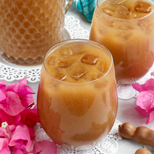 Refreshing homemade Tamarind Juice in glasses with ice cubes.
