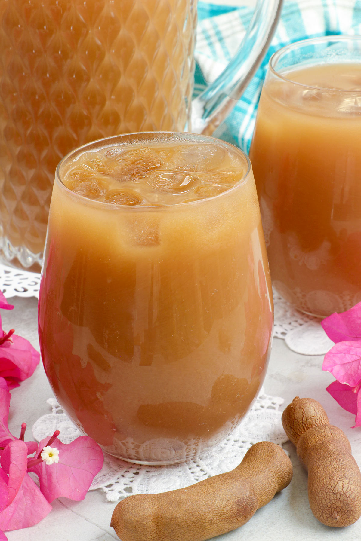 Refreshing homemade Tamarind Juice in glasses with ice cubes.