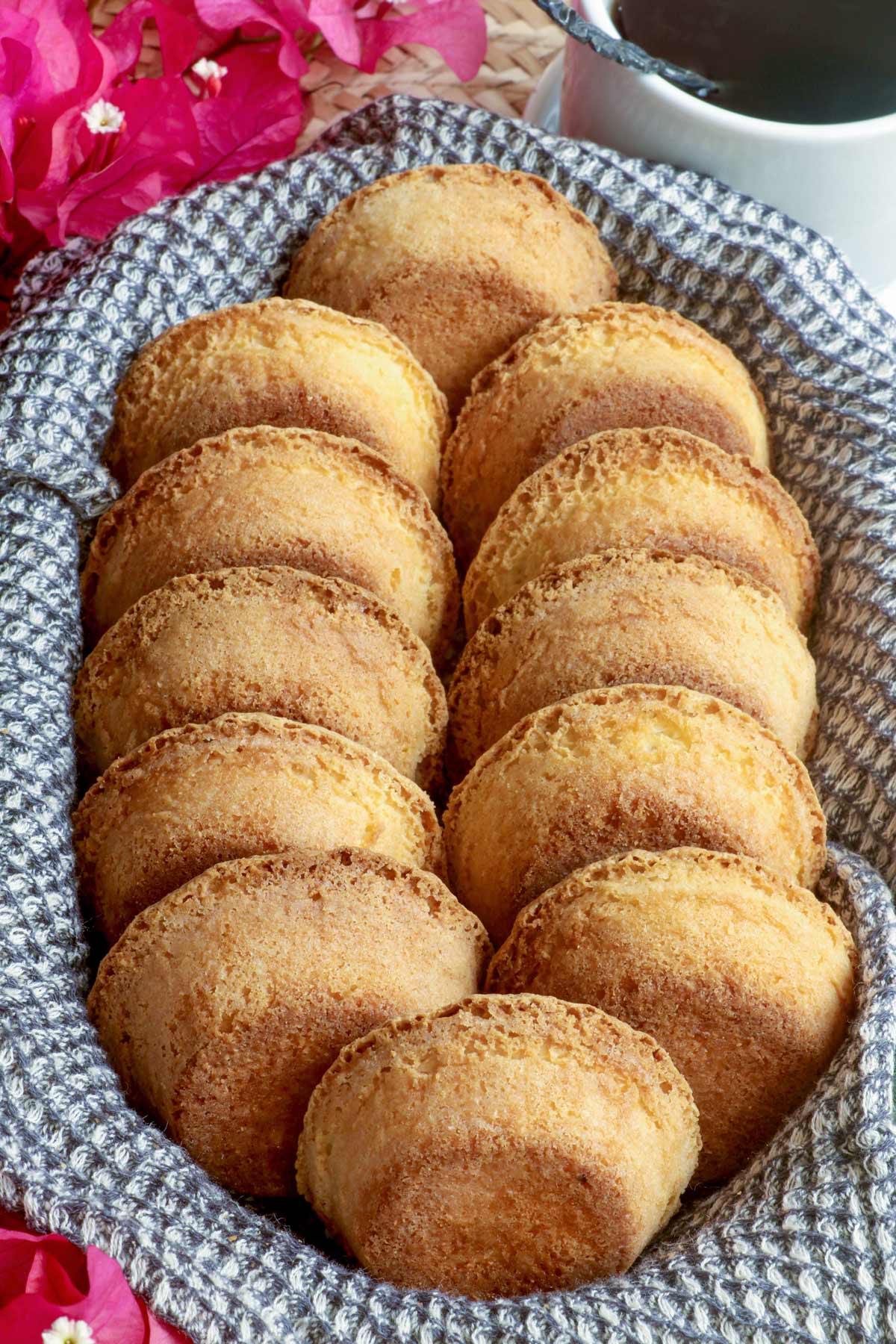 Freshly baked Mamon Tostado in a bread basket served with hot coffee.