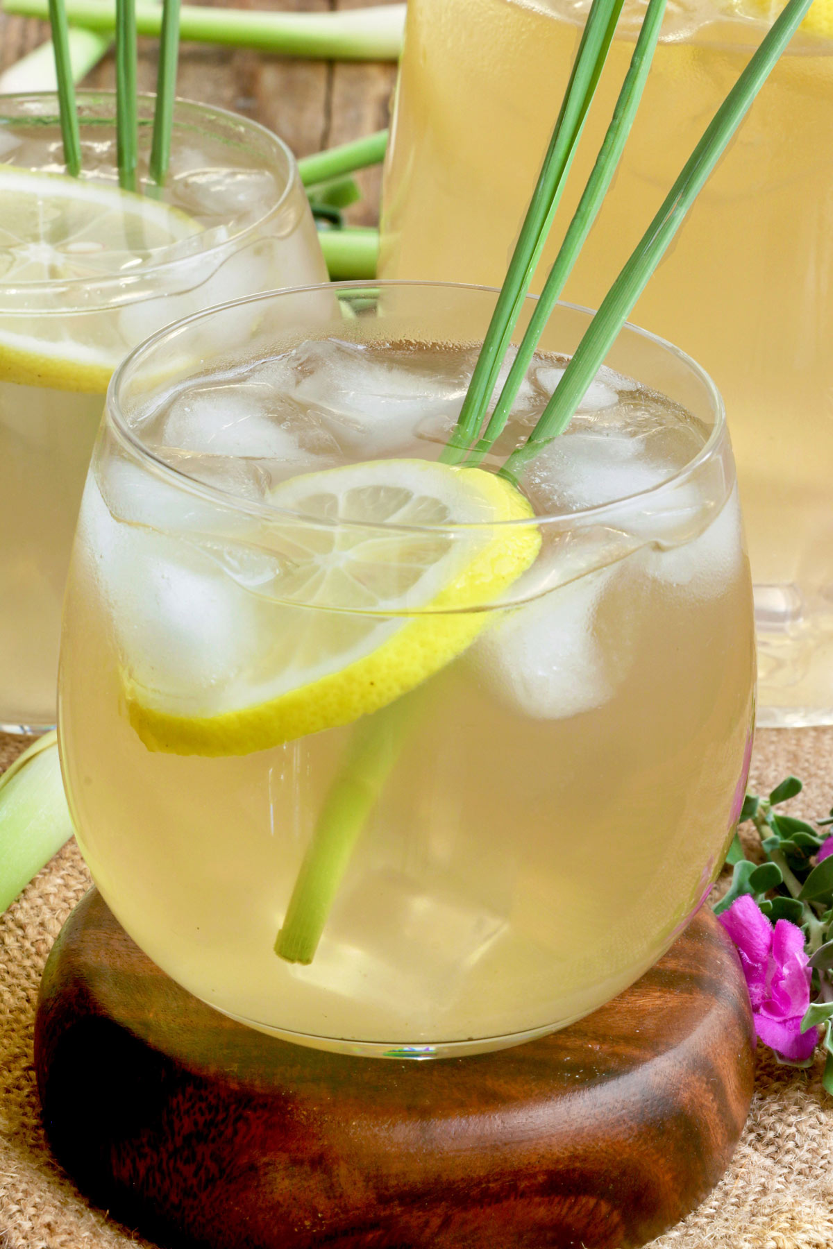 Lemongrass juice served in glasses over ice with slices of lemon and lemongrass.