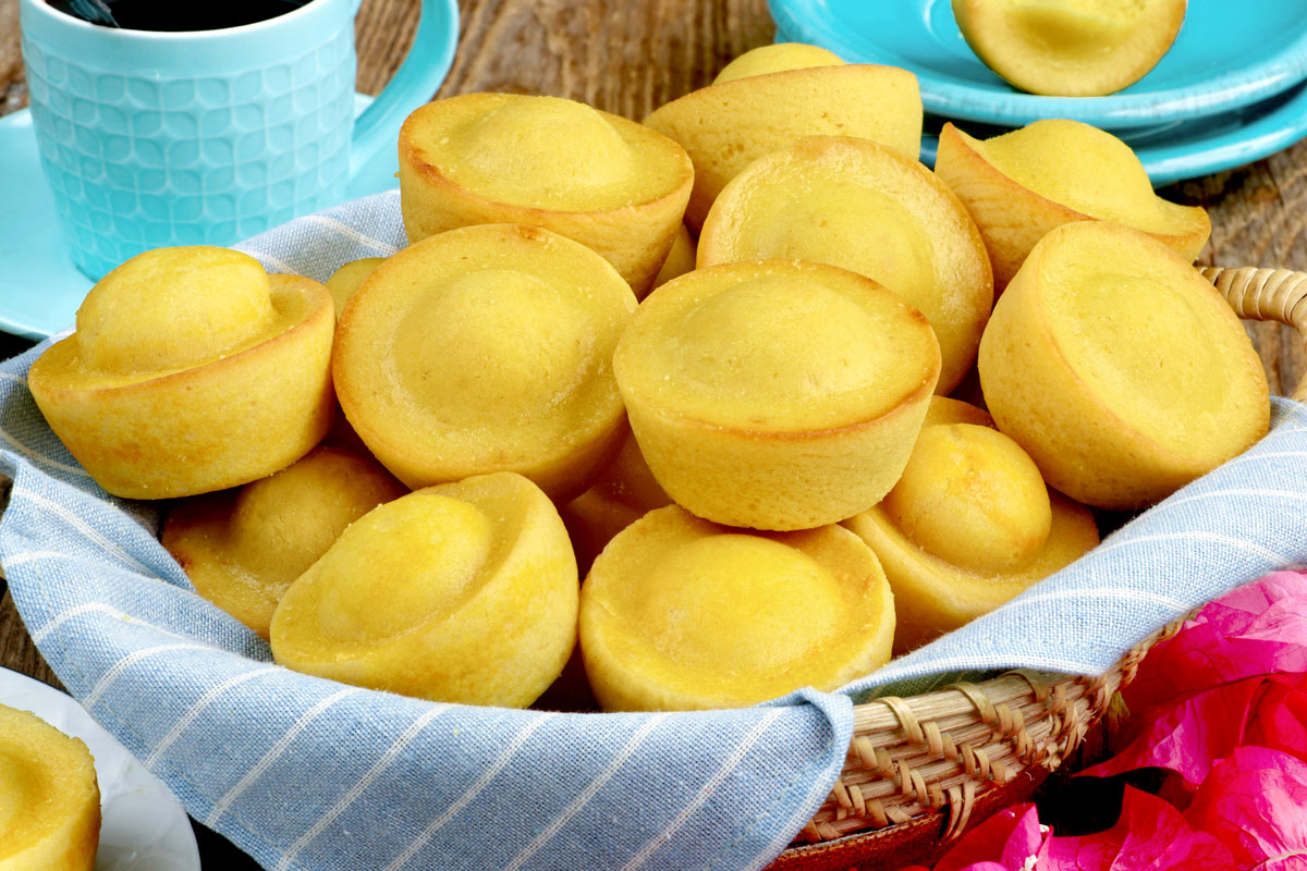 Kababayan bread in a serving basket served with a cup of coffee.