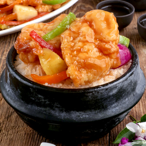 Rice topped with freshly cooked sweet and sour fish fillet with bell pepper strips and pineapple chunks.