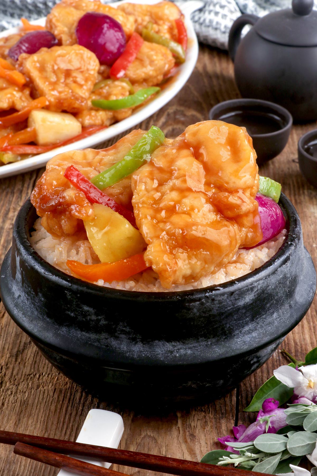 Freshly cooked sweet and sour fish fillet on top of a steamed white rice.