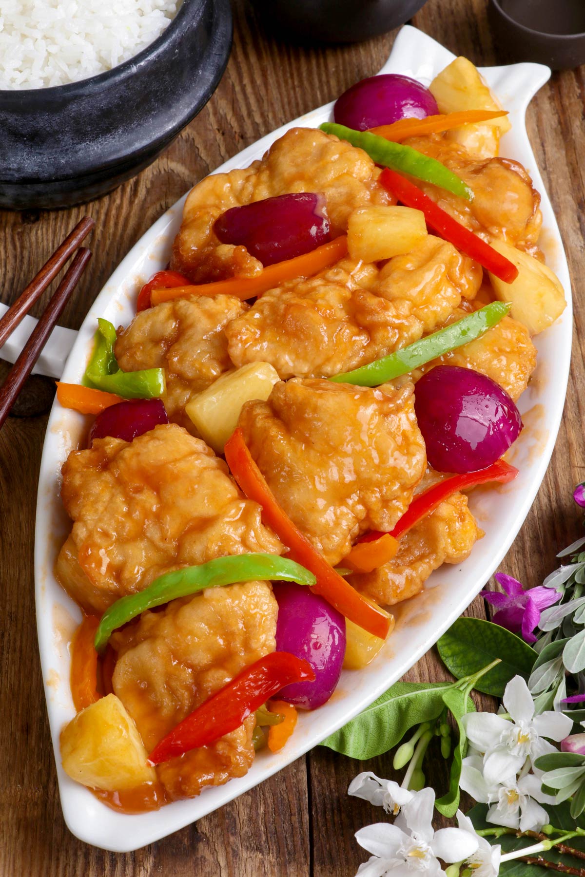 Sweet and Sour Fish with colorful bell pepper strips and pineapple chunks on a serving platter.