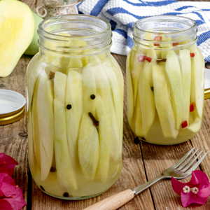 Sweet and tangy pickled mango in storage jars.