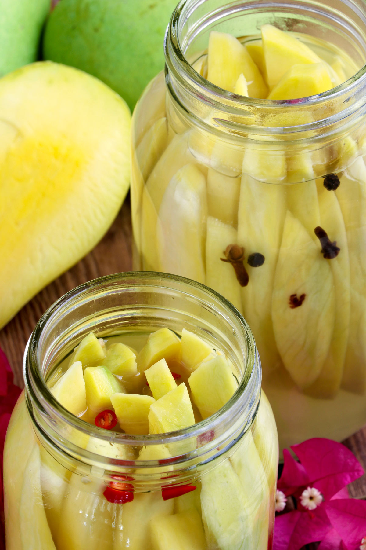 Pickled Mango made with almost ripe green mangoes, vinegar, sugar, salt, and water.