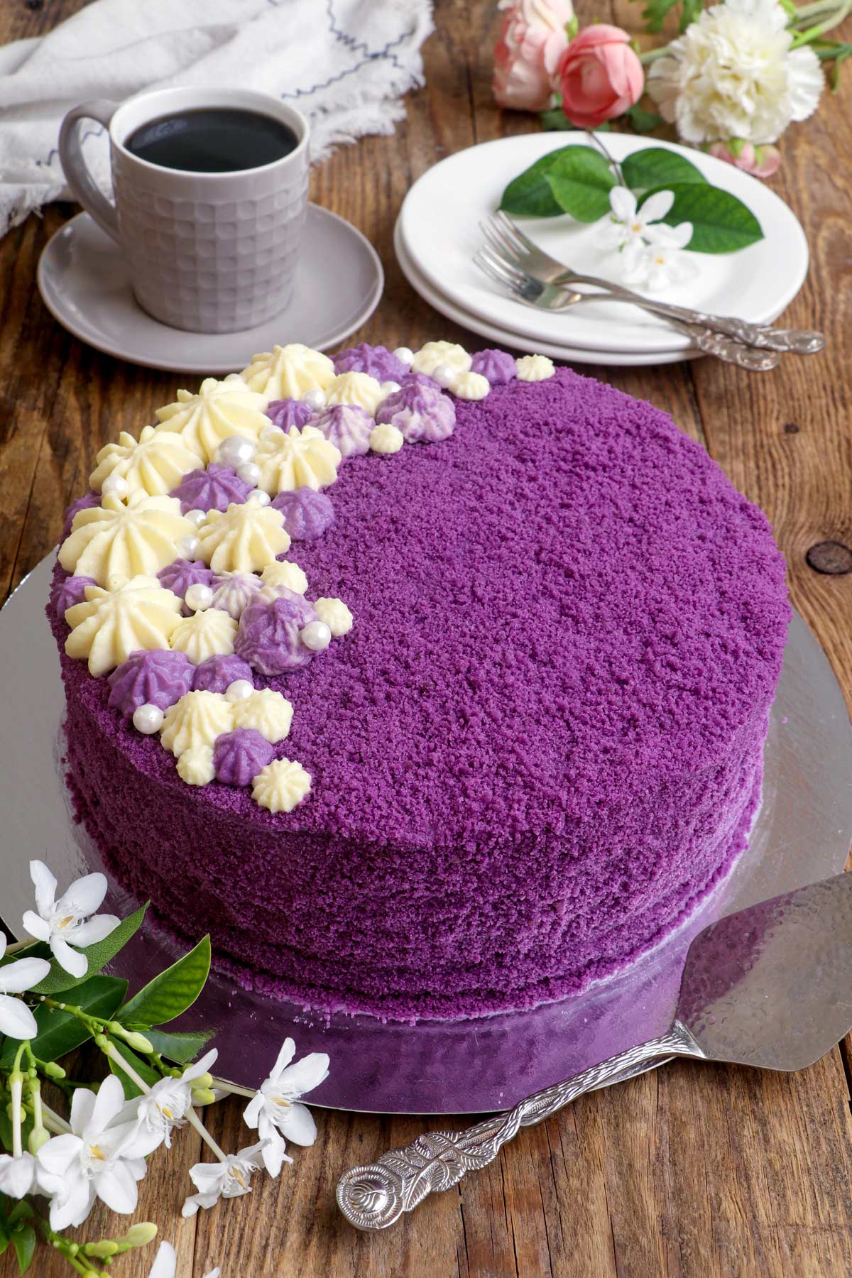 Round Ube Cake flower frostings, with coffee on the side.