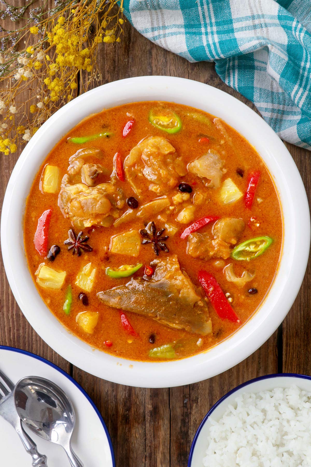 Balbacua is a Filipino stew made with ox feet with pineapple chunks, pork and beans and bell pepper simmered in a hearty stew flavored with annatto, star anise, and peanut butter.