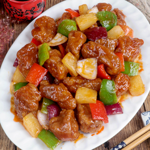 Sweet and Sour Pork with pineapples, bell peppers, and red onion smothered in a silky sauce.