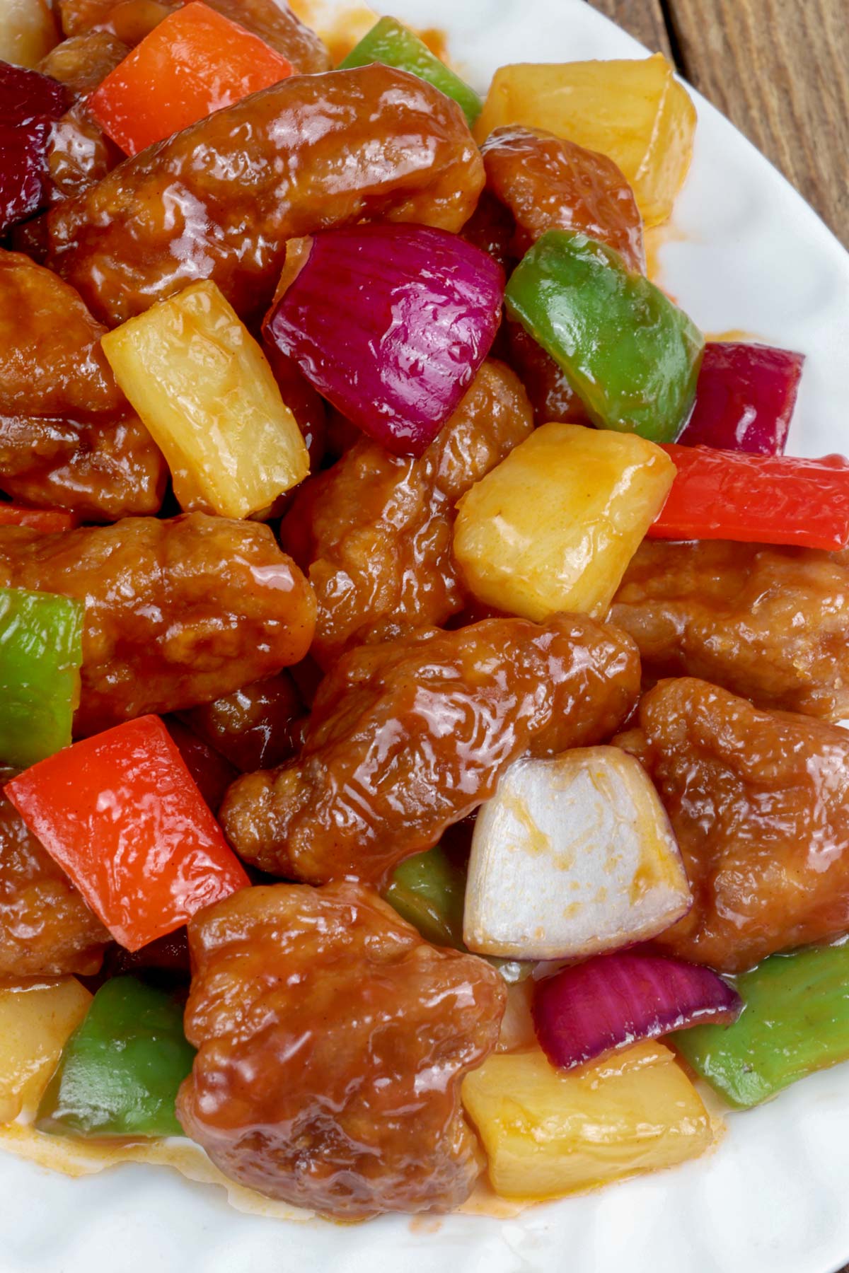 Sweet and Sour Pork with pineapples, bell peppers, and red onion smothered in a silky sauce.