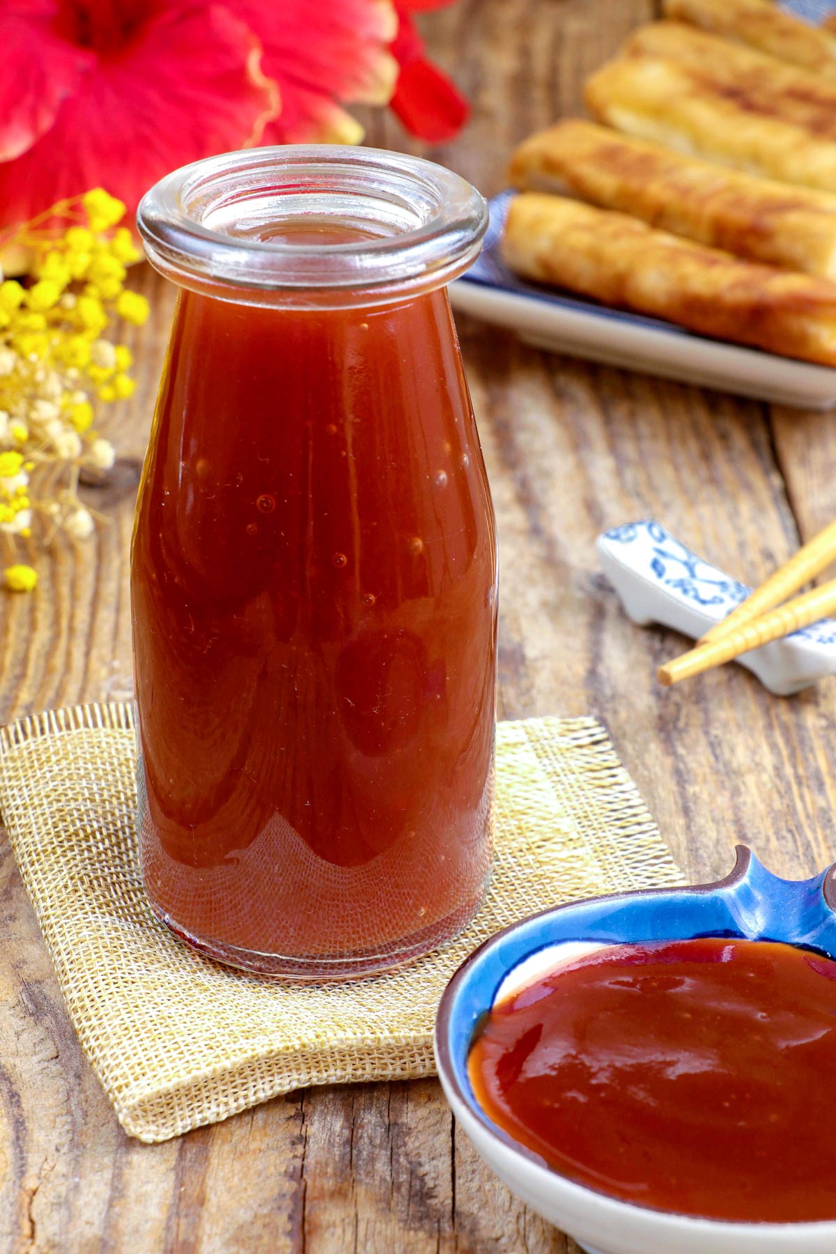 Sweet and sour sauce in a condiment jar as dipping sauce for fried spring rolls.