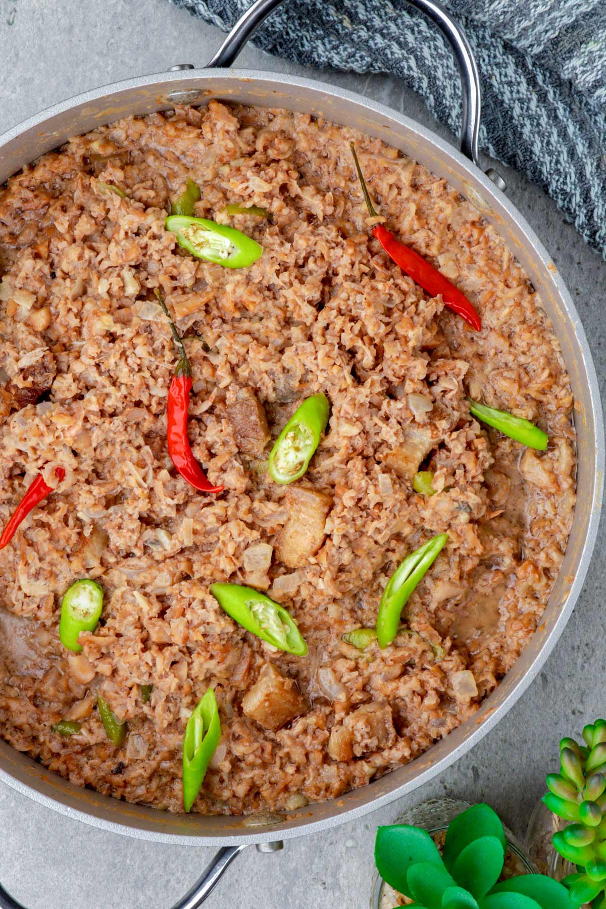 Ginataang Santol or Sinantolan in a pan with green and red chilis.