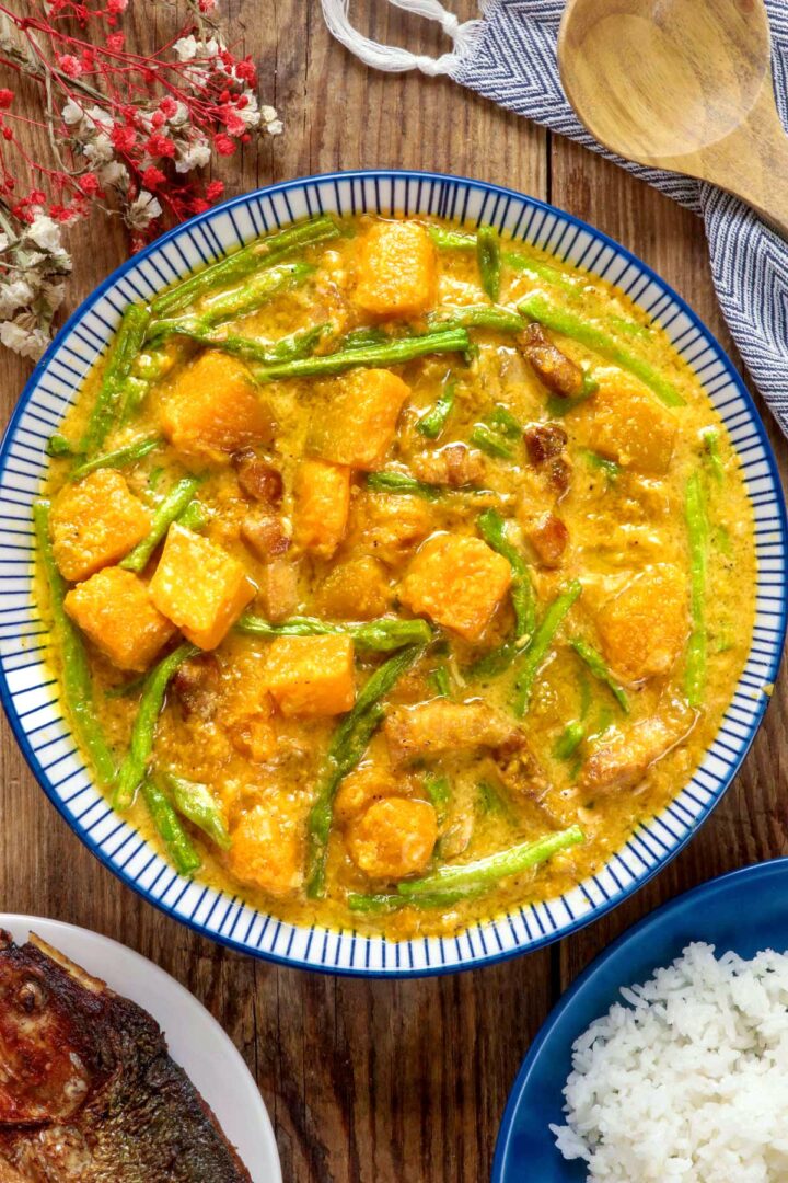 Ginataang Kalabasa at Sitaw in a serving bowl served with rice and fried fish.