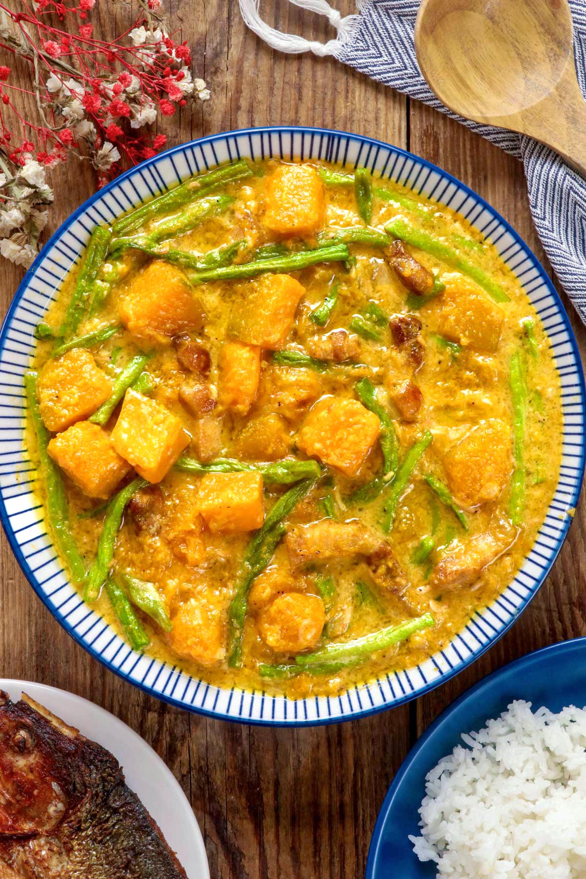 Ginataang Kalabasa at Sitaw in a serving bowl served with rice and fried fish.