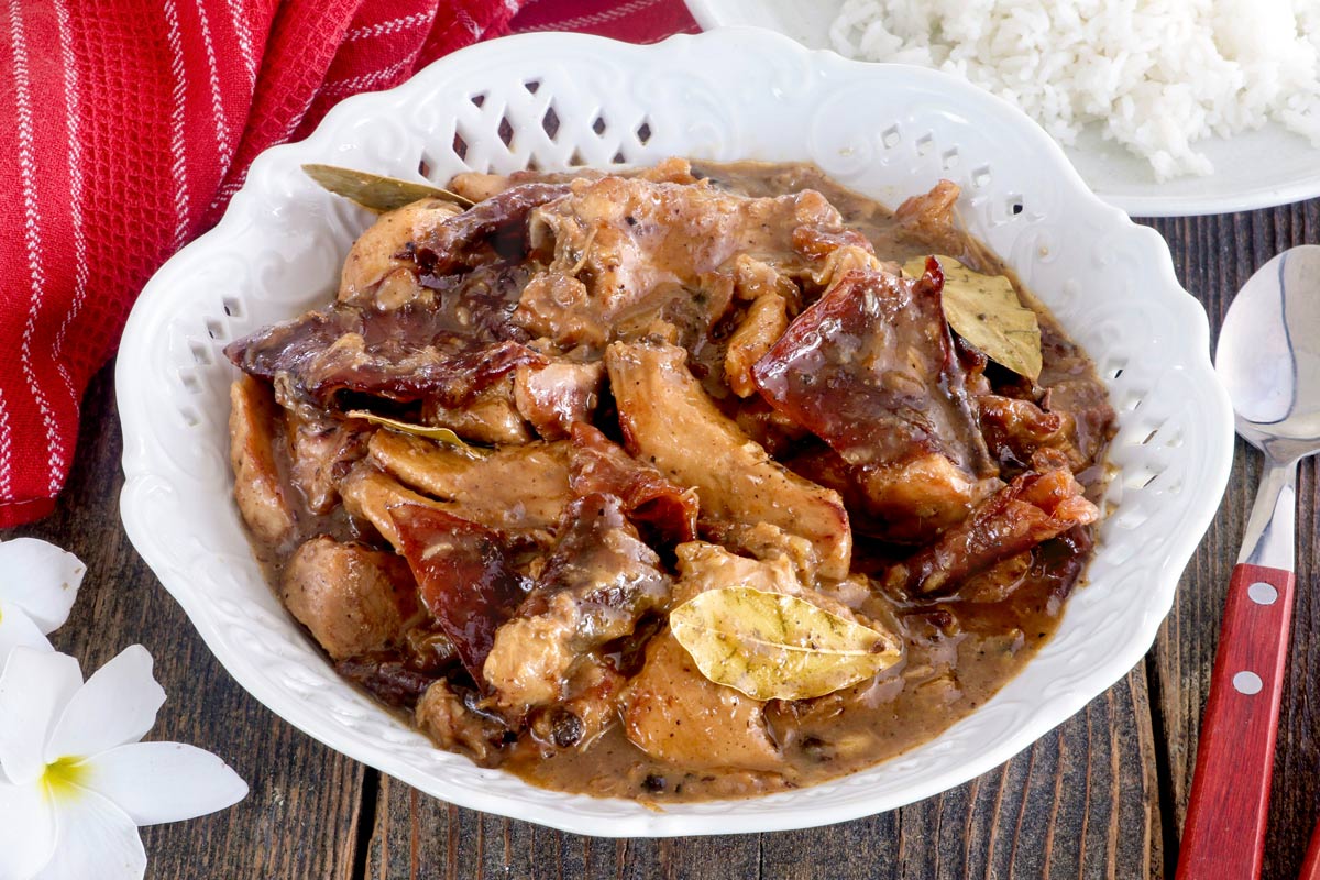 Lechon Paksiw in a serving platter served with steamed rice.