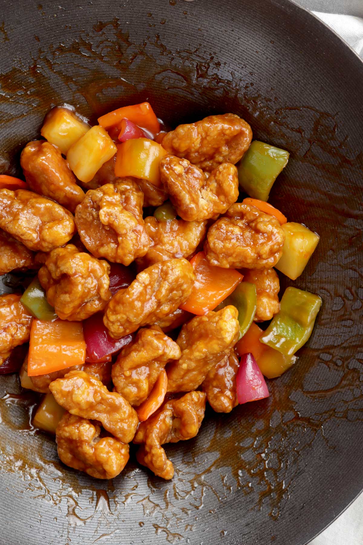 Freshly cooked sweet and sour pork in a wok.