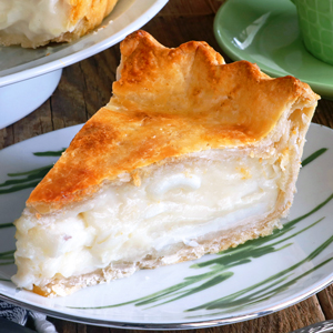 A slice of Buko pie on a plate showing the creamy coconut filling.