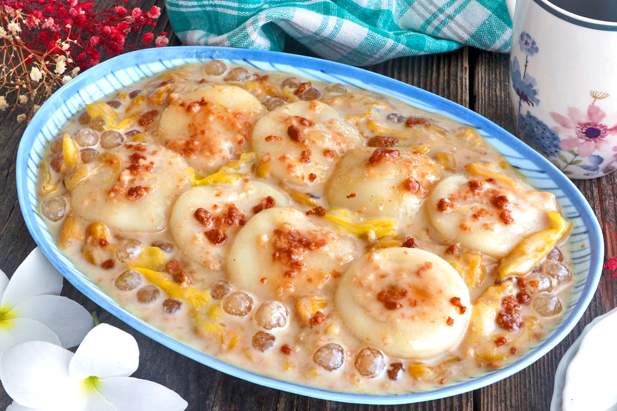 Soft and chewy palitaw in a sweet coconut sauce with langka, sago, and latik.