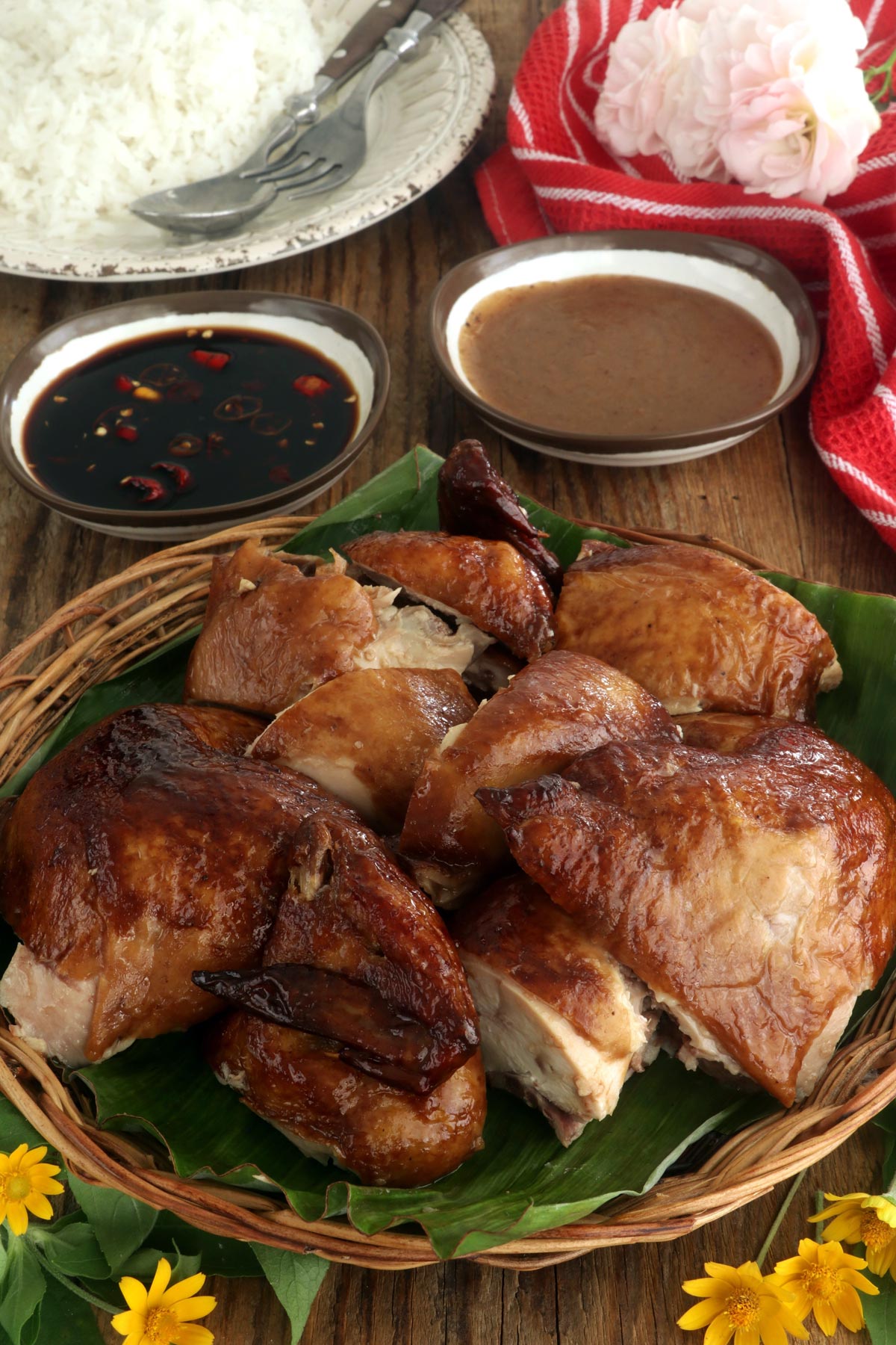 Carved lechon manok served with lechon sauce, spiced totyomansi, and steamed rice.