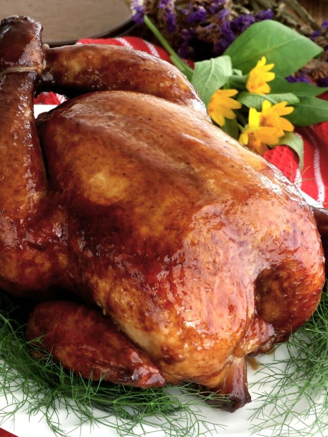 Whole lechon manok or roasted chicken on a serving plate.