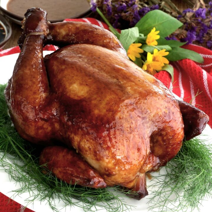 Whole lechon manok or roasted chicken on a serving plate.