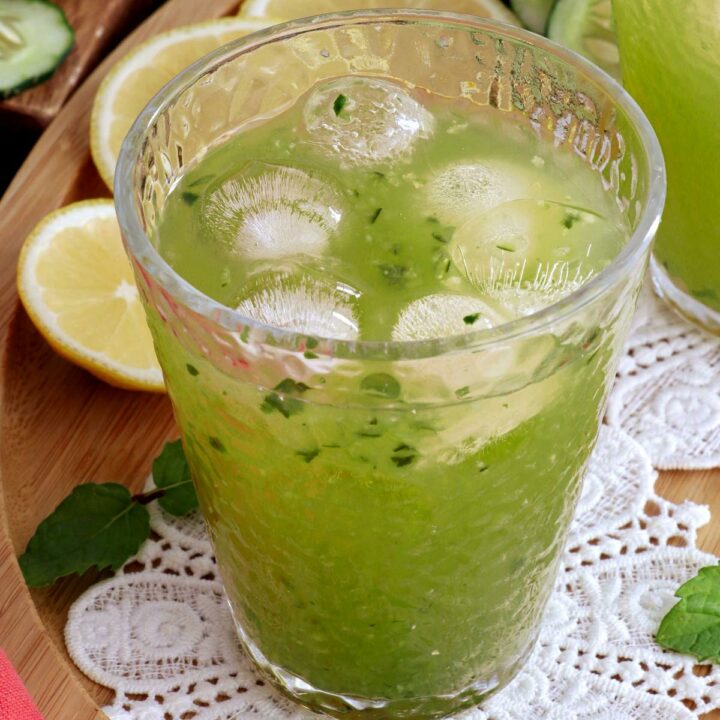 A glass of cucumber juice served over ice.