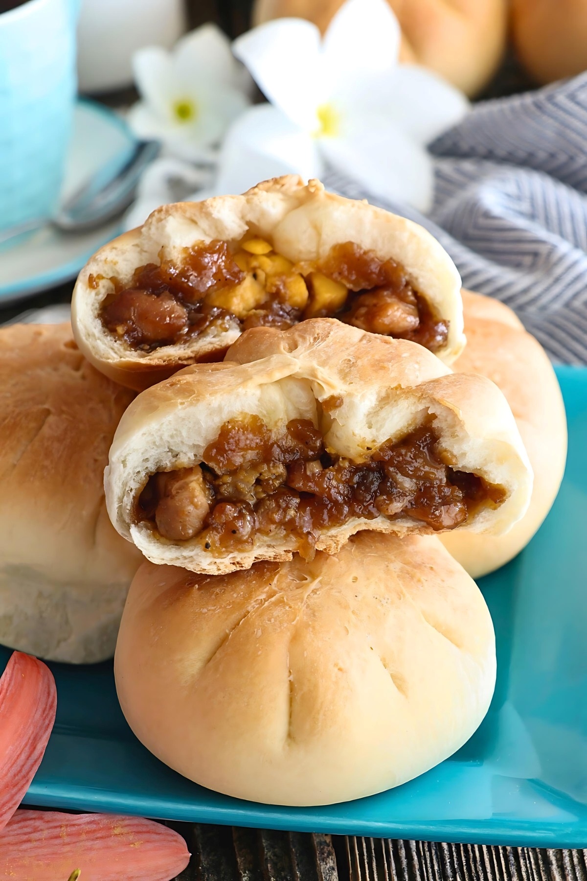 Toasted siopao in half with chicken asado and hard-boiled egg filling.