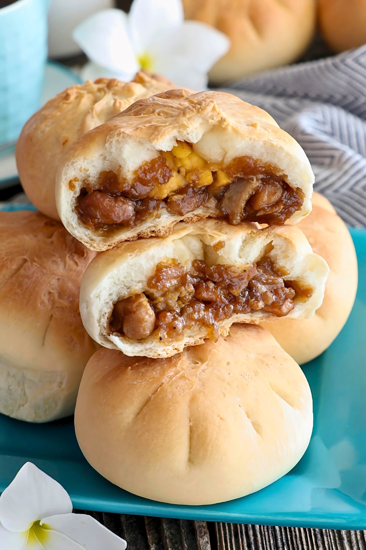 Toasted siopao in half with chicken asado and hard-boiled egg filling.