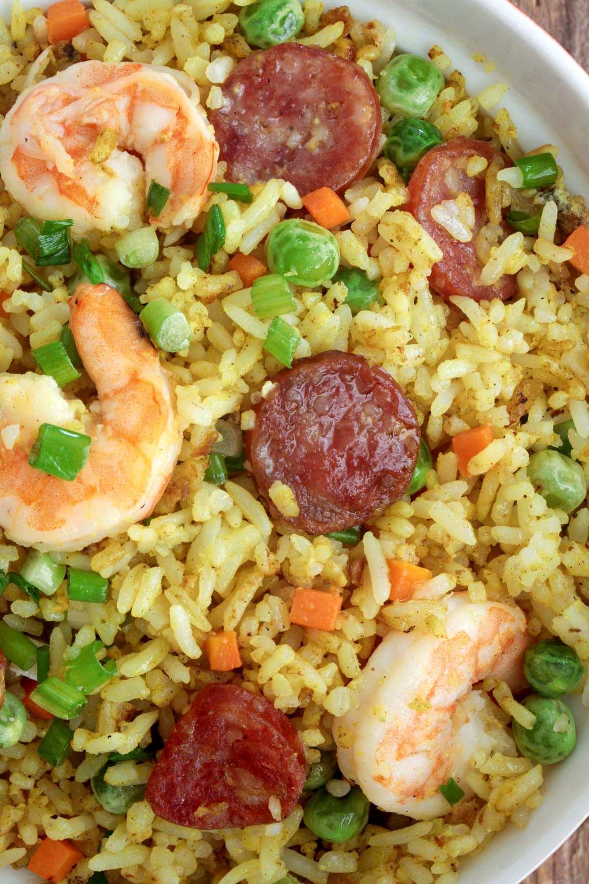 Yang Chow fried rice loaded with shrimp, sausages, eggs, carrots, and green peas.