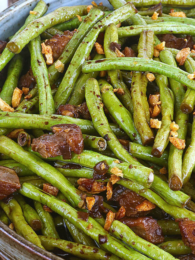 Adobong sitaw with pork belly topped with fried garlic bits.