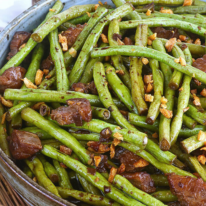 Adobong sitaw with pork belly topped with fried garlic bits.